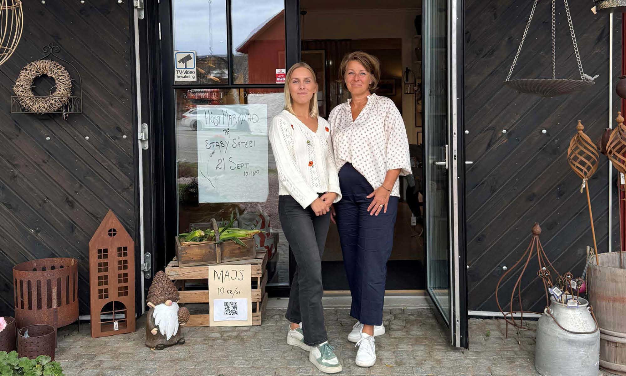 Mother and daughter in front of their store 