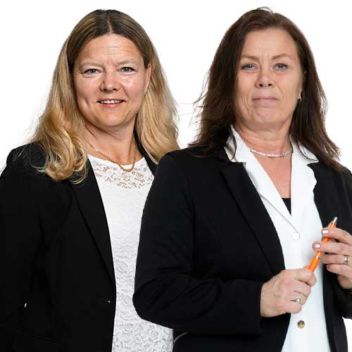 two women in white shirts and dark jackets looking into the camera