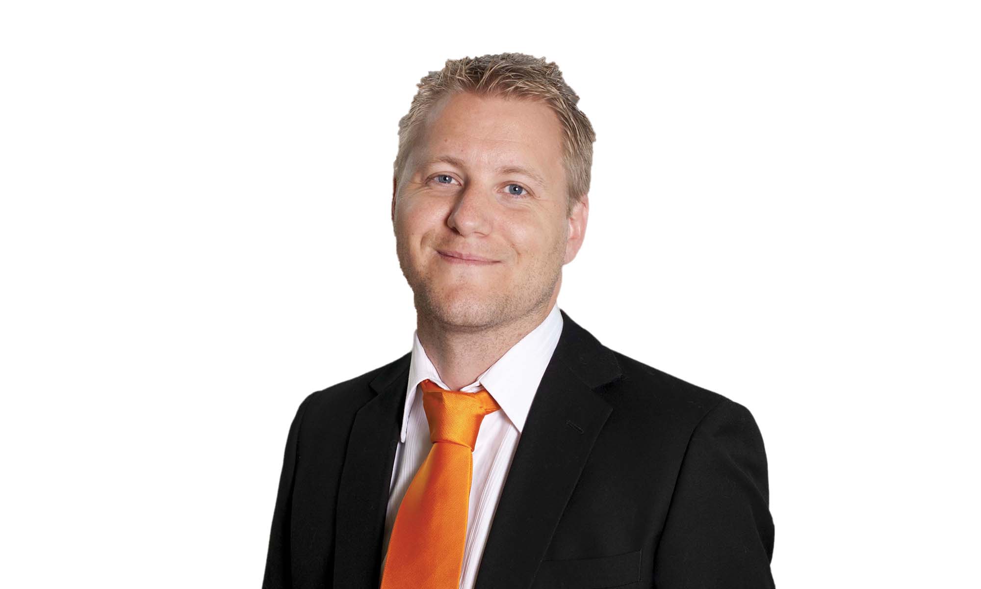 man in black suit with white shirt and orange tie 